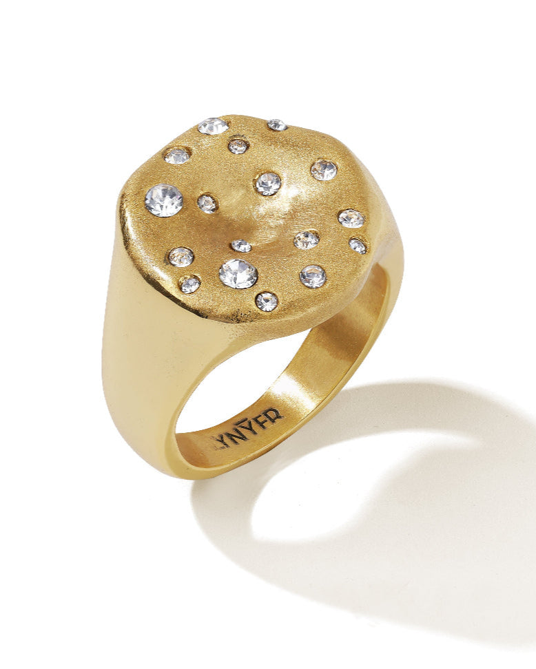 Chunky brushed gold ring with zirconia stones, shown on model’s hand for a bold statement look