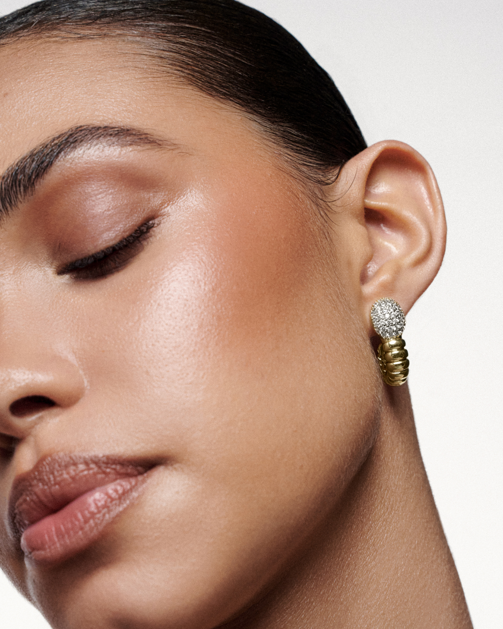 Elegant serpent-inspired earrings crafted in gold-plated brass with zirconia accents