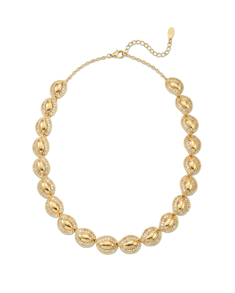 Sculptural statement Gold necklace with leaf-like pendants on a white background