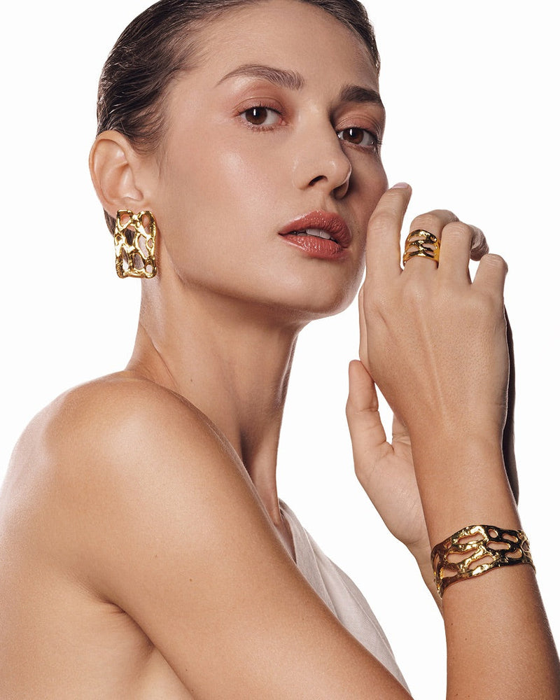Gold-plated Mystic Embossed Cuff Bracelet with intricate detailing and an open adjustable fit—ideal as a statement piece or for layering with other bold gold jewelry.
