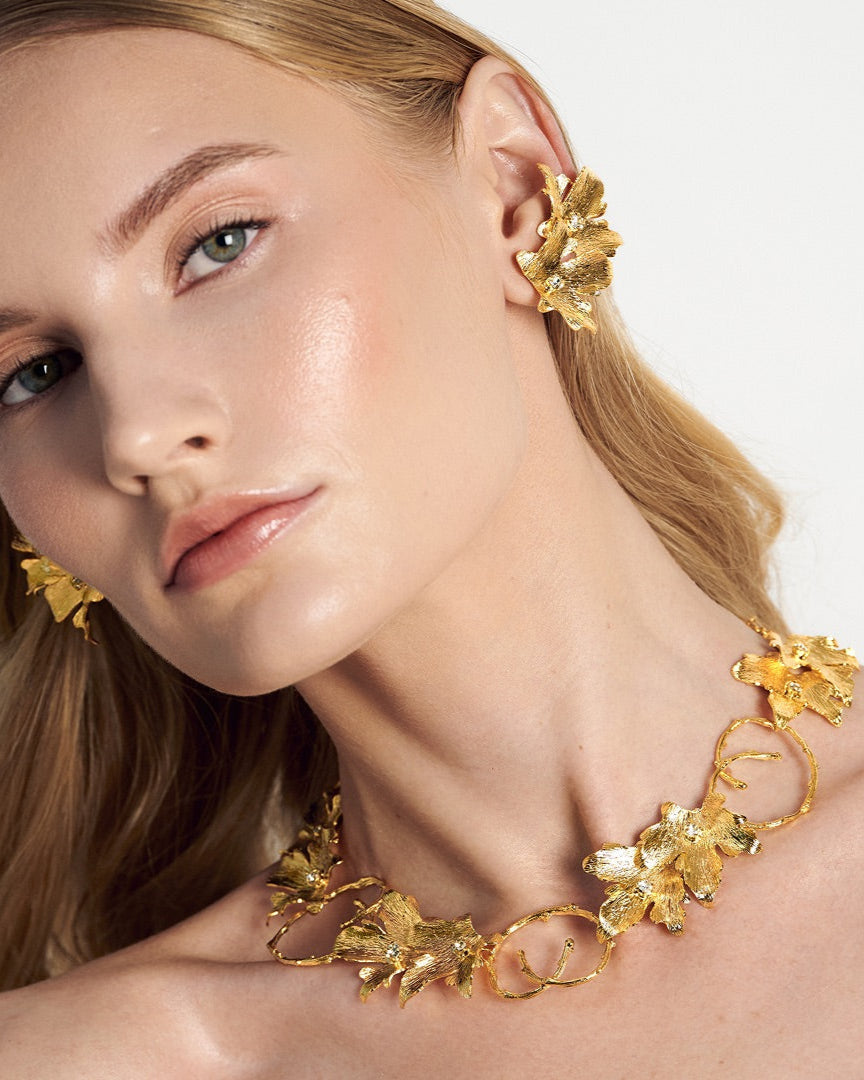Elegant gold choker necklace paired with ear cuff with vine leaf detailing, handcrafted in 24k gold for a luminous, nature-inspired look – perfect for weddings or statement layering.
