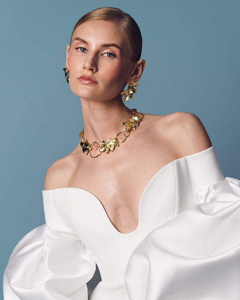 Bridal gold ear cuff and necklace with vine leaf design, perfect for wedding hair and makeup looks; adjustable for comfort and pairs beautifully with matching necklace and ring.