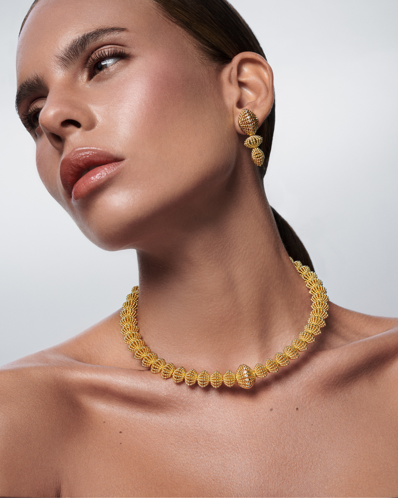 Elegant gold dangle earrings and necklace from the Ravi Nova Collection