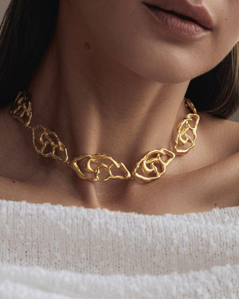 Layering gold necklace with modern pendant