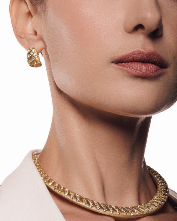 Glamorous chunky gold hoops paired with matching necklace