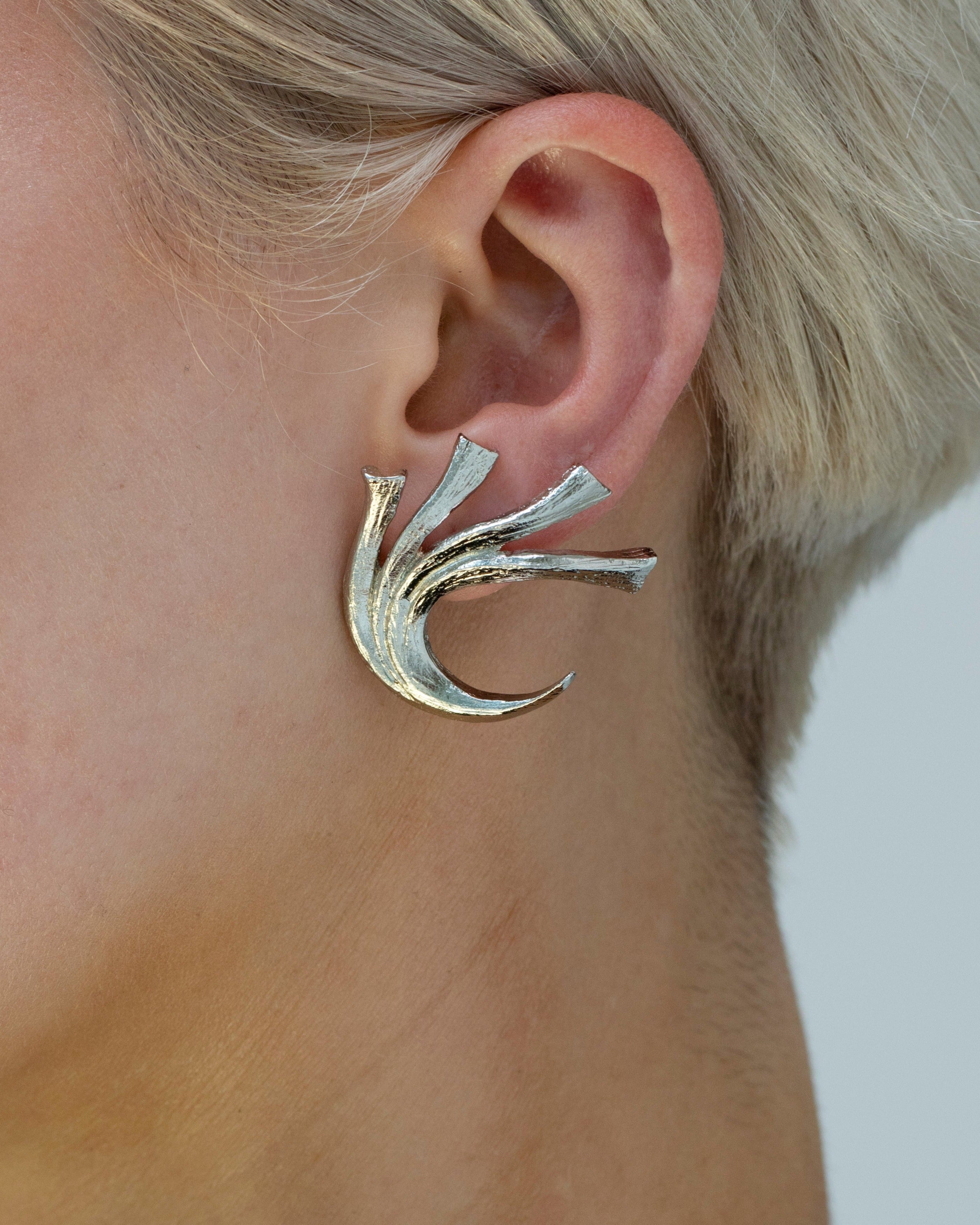 Botanical silver earrings that trace the ear
