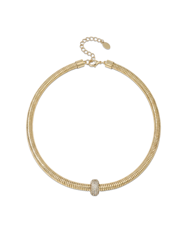Gold necklace with ribbed texture designed as wearable statement piece that wraps naturally around the neckline