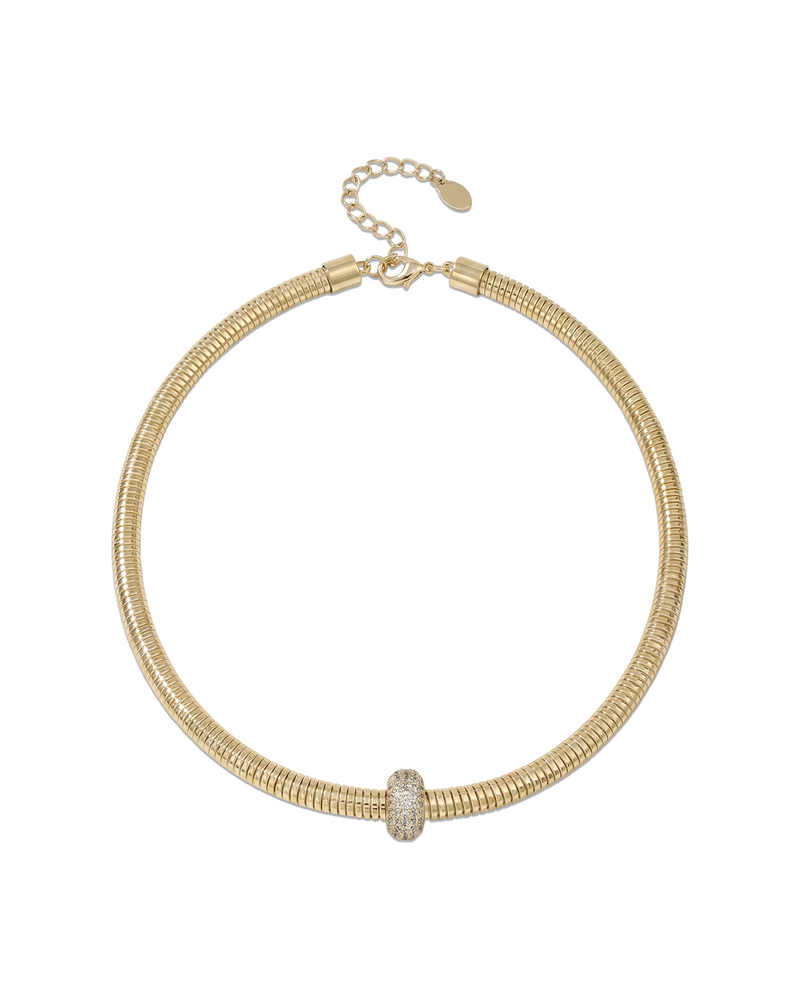 Gold necklace with ribbed texture designed as wearable statement piece that wraps naturally around the neckline