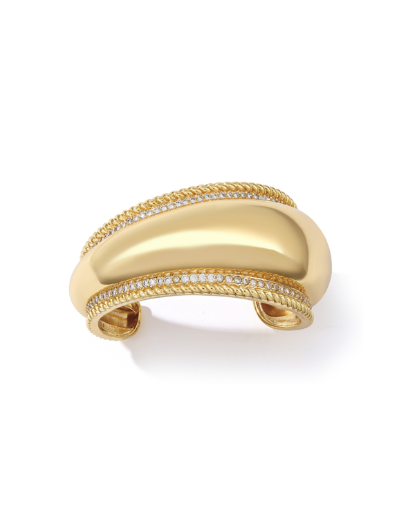 Gold statement sculptural bracelet with diamond accents on a 
