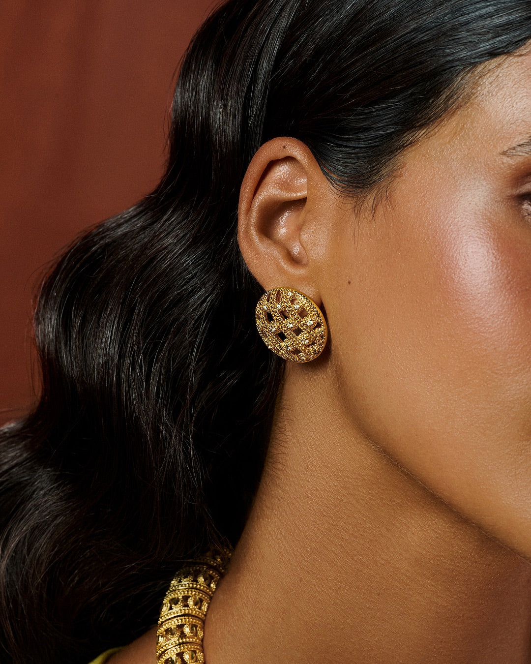 Handmade earrings with a sleek dome silhouette and radiant 24K gold plating
