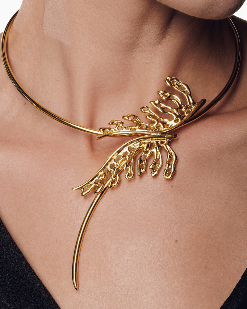 Handcrafted gold collar necklace with a blooming leaf design, blending elegance and strength for a bold, mystical statement.