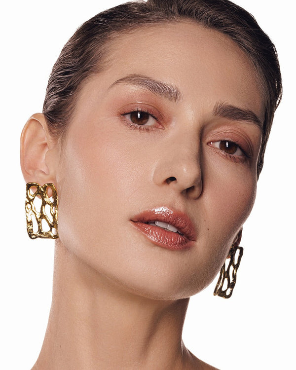 Gold drop earrings with leaf-inspired design – minimalist statement jewelry for casual or formal wear.