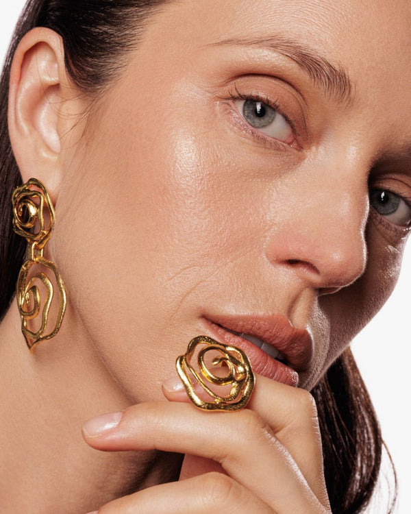 Stackable gold ring styled with minimalist jewelry