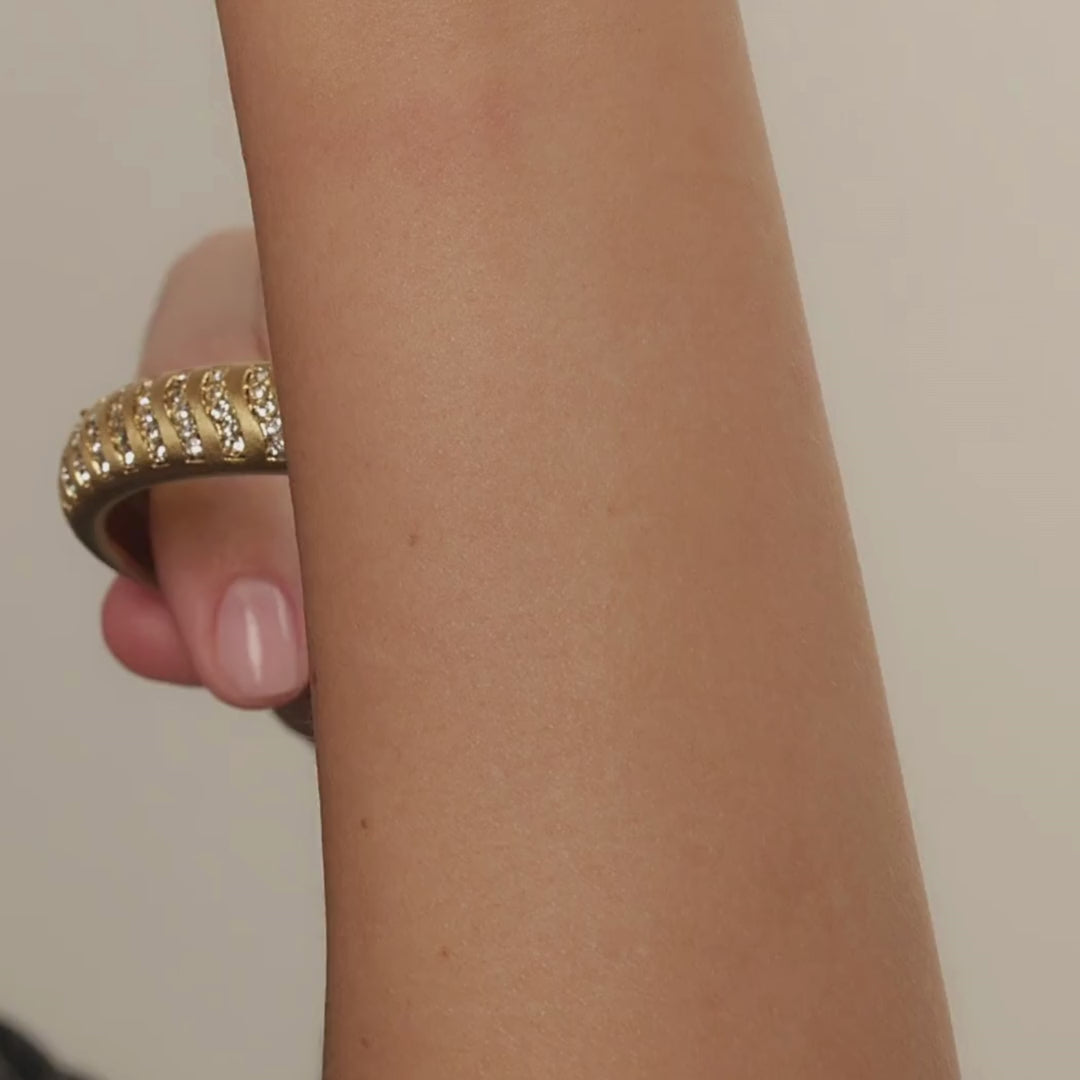 chunky gold plated bangle with zirconia studs lines