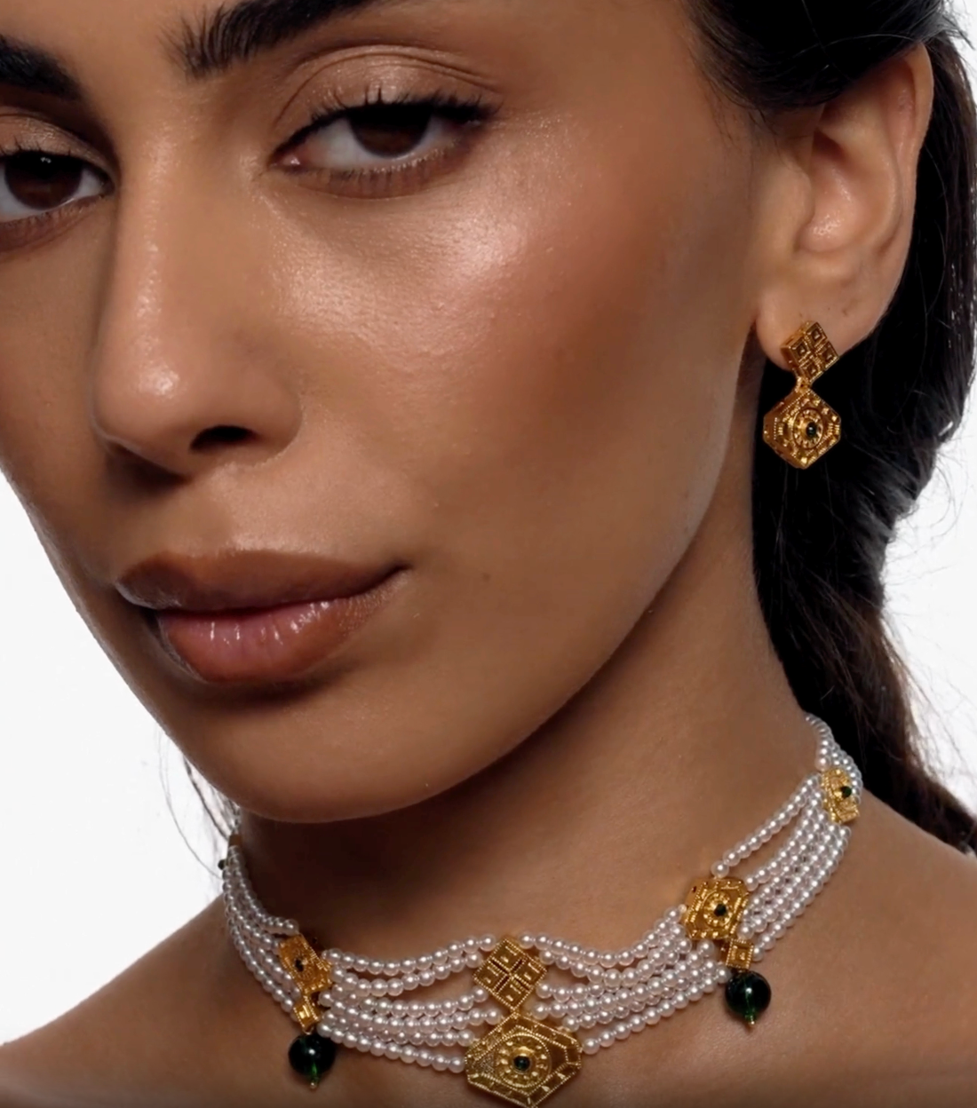 Gold geometric drop earrings with emerald detail