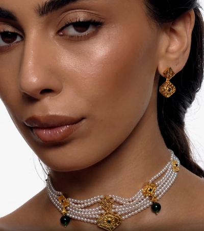 Gold geometric drop earrings with emerald detail