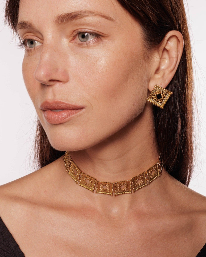 Diamond-shaped gold choker styled for modern wear
