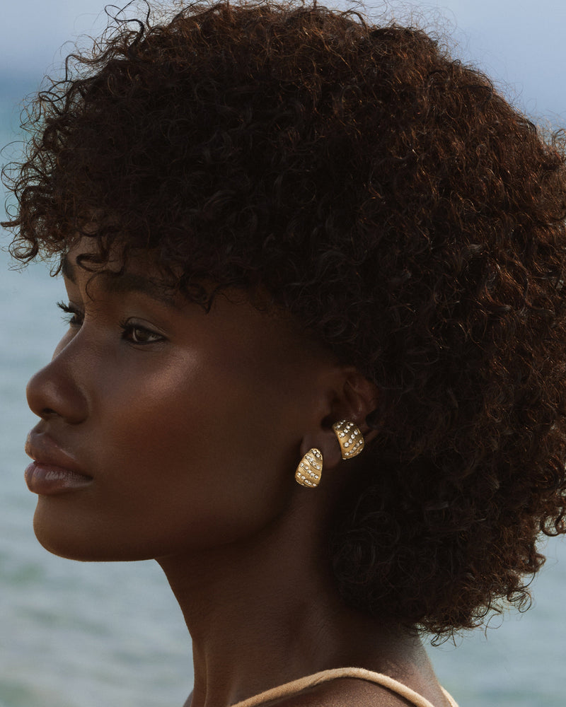 Close-up of sculptural gold earcuff for women’s jewelry collection