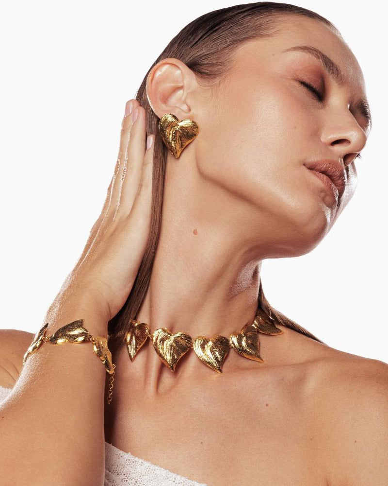 Layered gold necklace with heart-shaped charm