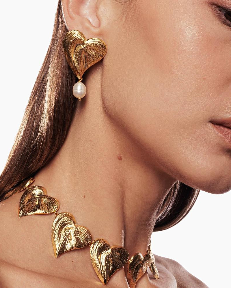 Classic pearl drop earrings featuring heart design