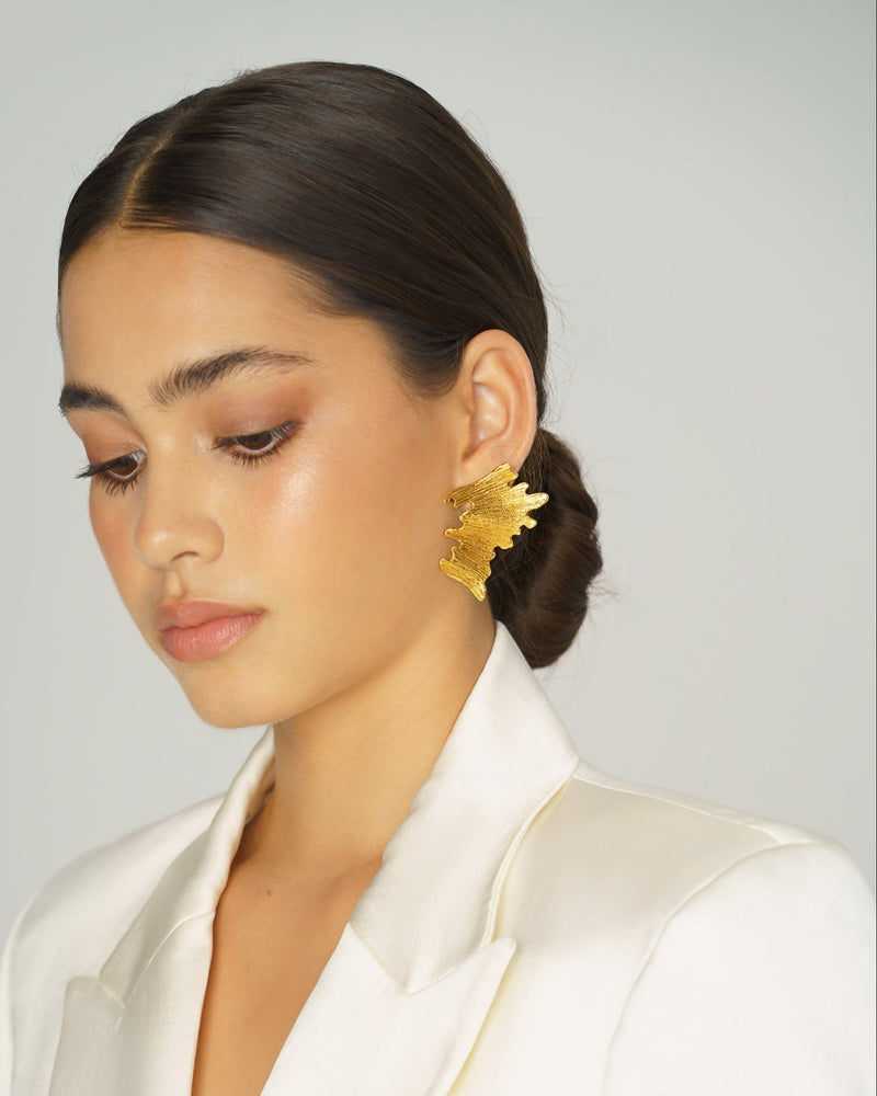Abstract gold earrings inspired by lava flow